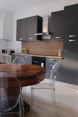 a kitchen with a wooden table and chairs at Galleria del Principe in Rome