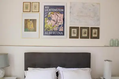 a bedroom with a bed and some framed pictures at Galleria del Principe in Rome