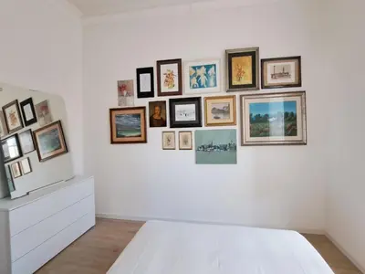a white wall with a bunch of pictures on it at Galleria del Principe in Rome