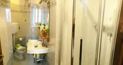 a bathroom with a shower and a sink and a toilet at Casa Tua sul Tetto di Roma in Rome