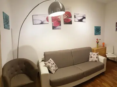 a living room with a couch and a lamp at Casa Tua sul Tetto di Roma in Rome