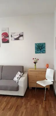 a living room with a couch and a chair at Casa Tua sul Tetto di Roma in Rome