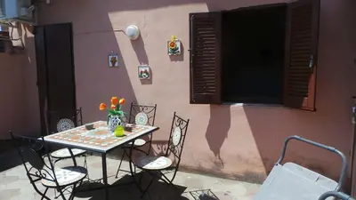 a table and chairs sitting in front of a building at Casa Tua sul Tetto di Roma in Rome