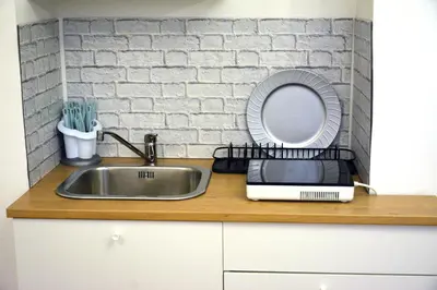 a kitchen counter with a sink and a mirror at Petit loft de Rome Vatican Apartment in Rome