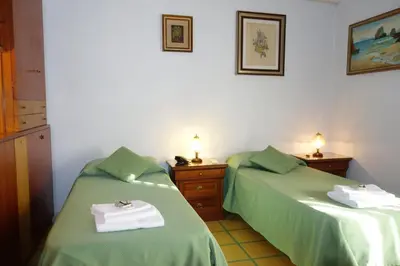 two beds sitting next to each other in a room at B&B Rome Downtown Deluxe in Rome