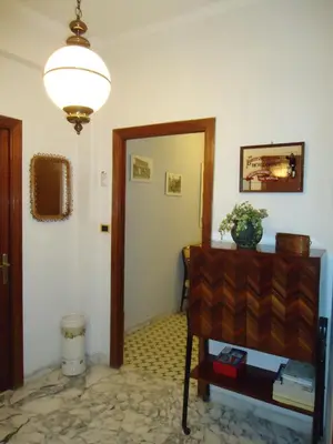 a hallway with a room with a table and a mirror at B&B Rome Downtown Deluxe in Rome