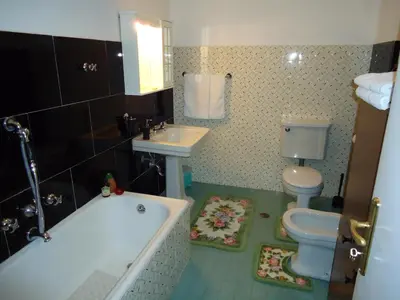 a bathroom with a tub and a toilet and a sink at B&B Rome Downtown Deluxe in Rome