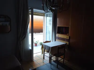 a small table and chair in a room with a window at B&B Rome Downtown Deluxe in Rome