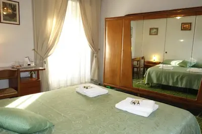 a bedroom with a bed and a large mirror at B&B Rome Downtown Deluxe in Rome