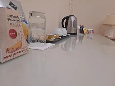 a counter top with a bottle of water and a blender at Suites Rome in Rome