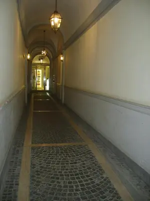 an empty hallway with a light fixture on the wall at Suites Rome in Rome