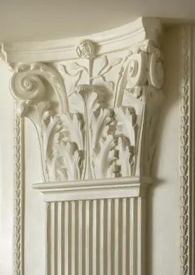 a white wall with a carving on it at Suites Rome in Rome