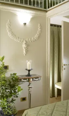 a room with a table with a candle on a wall at Suites Rome in Rome