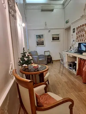 a living room with a table and a christmas tree at Suites Rome in Rome