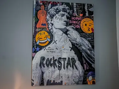 a painting of a man with graffiti on a wall at Casa Celestina Roma in Rome