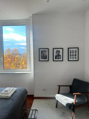 a living room with a couch and a window at Maison Merulana Colosseo in Rome
