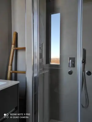 a shower with a glass door in a bathroom at Maison Merulana Colosseo in Rome