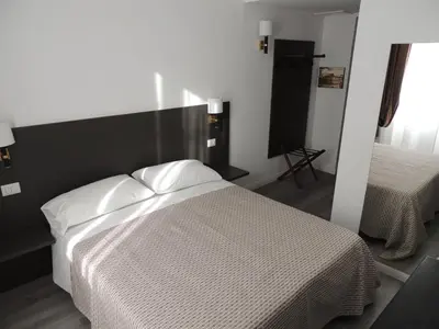 a bedroom with a bed with white sheets at Madonna della Neve in Rome