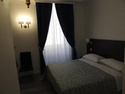 a bedroom with a bed and a large window at Madonna della Neve in Rome