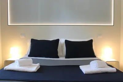 a bed with two towels sitting on top of it at Little Rose Lodge in Rome
