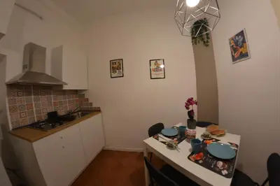 a kitchen with a table with dishes on it at La maison de Rome Vatican Apart in Rome