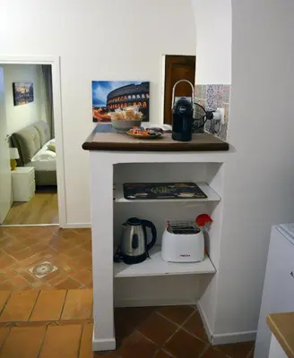 a kitchen with a counter with a stove at La maison de Rome Vatican Apart in Rome