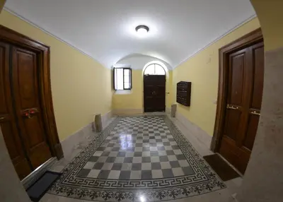a hallway with a checkered floor and two doors at La maison de Rome Vatican Apart in Rome