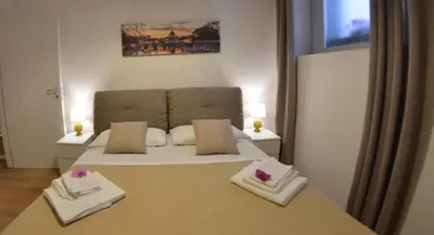 a bedroom with a bed with two white towels at La maison de Rome Vatican Apart in Rome