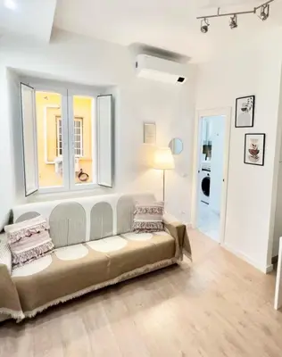 a living room with a couch and a window at Saint Peter 78 - Design Apartment in Rome