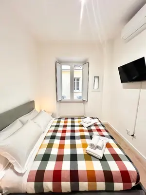 a bedroom with a bed with a checkered floor at Saint Peter 78 - Design Apartment in Rome