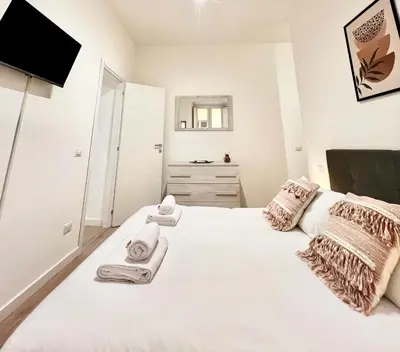 a bedroom with a white bed with towels on it at Saint Peter 78 - Design Apartment in Rome