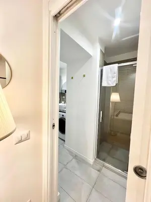 a bathroom with a shower and a glass door at Saint Peter 78 - Design Apartment in Rome