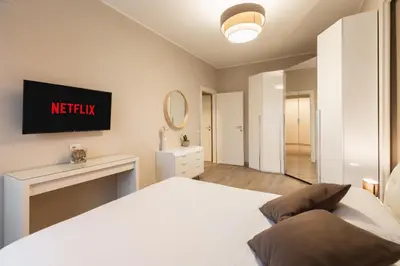 a bedroom with a bed and a tv on the wall at Albadomus Apartment in Rome