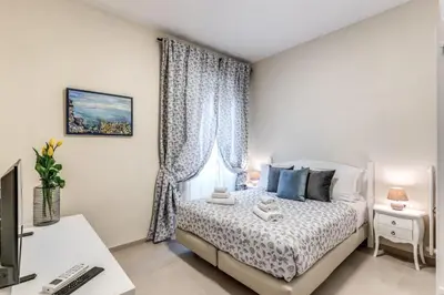 a bedroom with a bed and a desk with a computer at INN3 APT in Rome