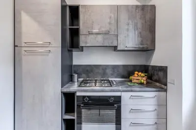 a kitchen with stainless steel cabinets and a stove at INN3 APT in Rome