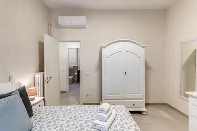 a bedroom with a bed and a white cabinet at INN3 APT in Rome