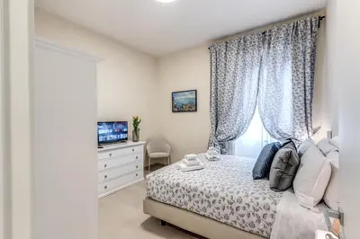 a bedroom with a bed and a dresser with a television at INN3 APT in Rome