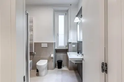 a bathroom with a white toilet and a sink at INN3 APT in Rome