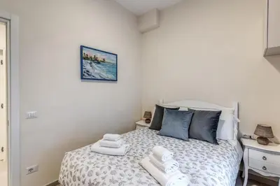 a bedroom with a bed with towels on it at INN3 APT in Rome