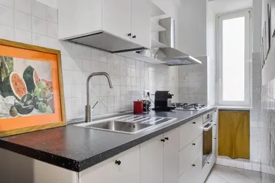 a kitchen with a sink and a counter top at Yellow Stripes Apartment - San Giovanni by RHR in Rome