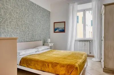 a bedroom with a bed with a yellow blanket at Yellow Stripes Apartment - San Giovanni by RHR in Rome