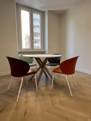 a table and chairs in a room with a window at Vittoria's Luxury Rooms in Rome