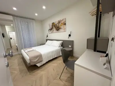 a hotel room with a bed and a chair in it at Vittoria's Luxury Rooms in Rome