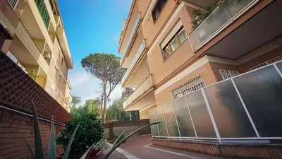 a building with a fence on the side of it at ROMA BeMa Apartment - charme e relax a due passi dal Vaticano in Rome