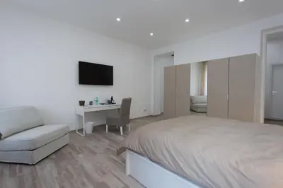 a bedroom with a bed and a chair and a desk at Navona 68 in Rome