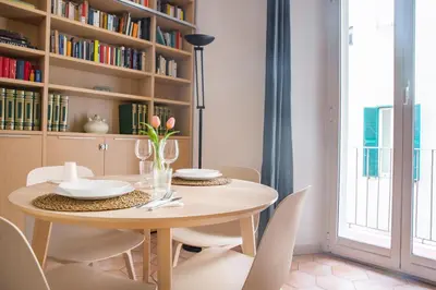 a dining room with a table and chairs at Professor's house in Porta Pia in Rome