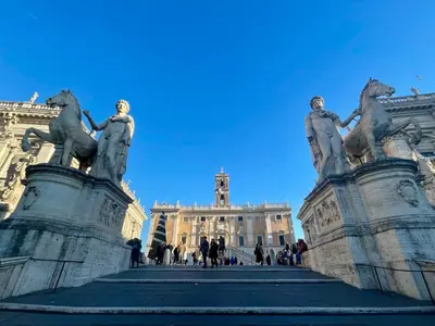 a staircase in front of a building with statues at Professor's house in Porta Pia in Rome