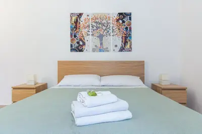 a bedroom with a bed with towels on it at Professor's house in Porta Pia in Rome