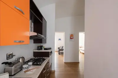 a kitchen with a stove and an orange cabinet at Casa Filiberto in Rome