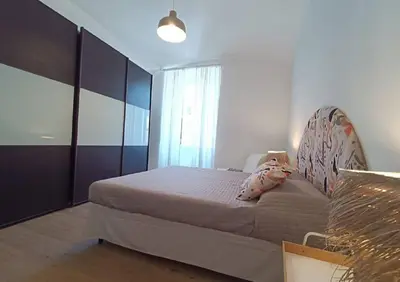 a bedroom with a bed with a headboard and a window at Casa Filiberto in Rome